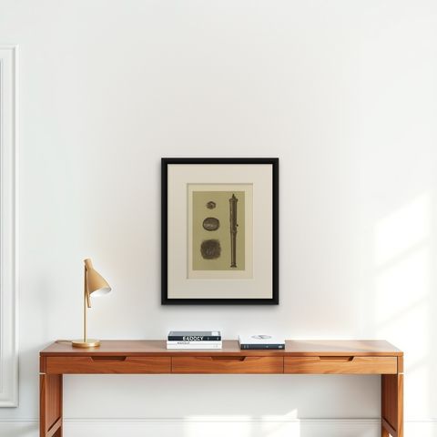 Antique Print of a Bronze Cannon by Gibb, 1890, shown framed on a wall